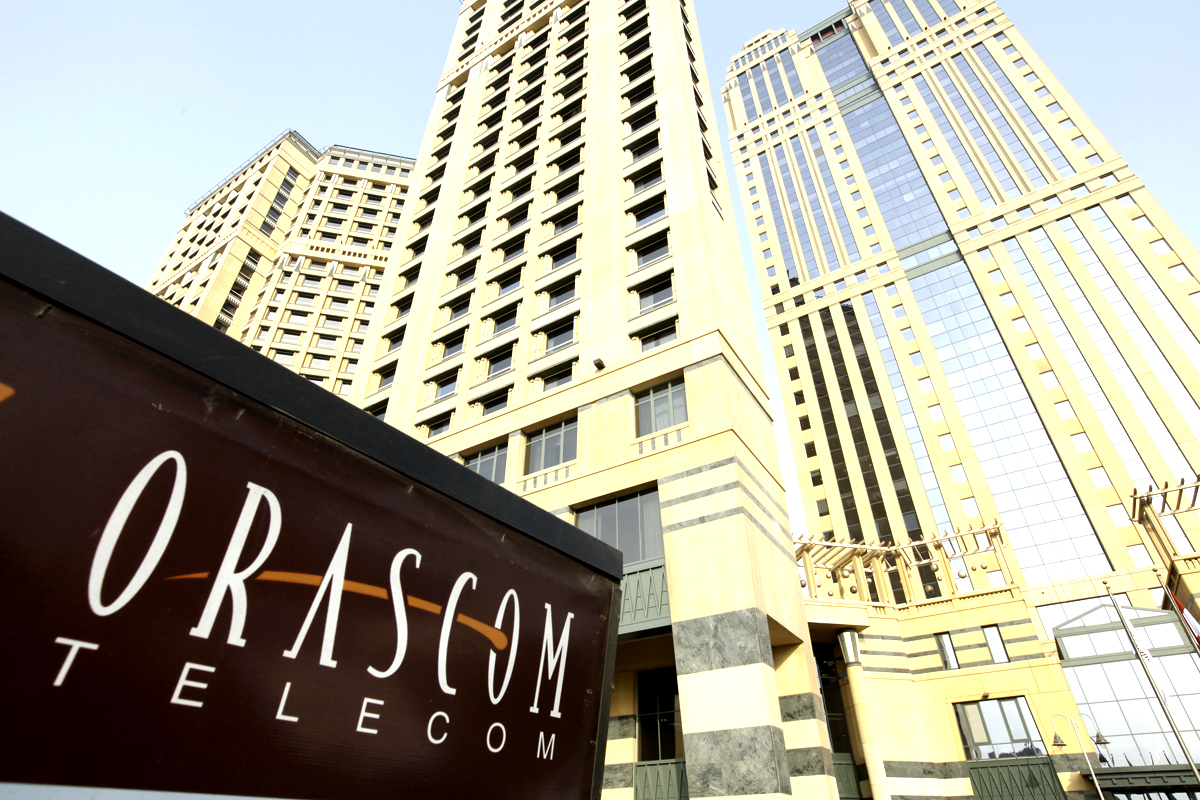 An Orascom Telecom Holding SAE sign sits outside the company's headquarters at Nile City Towers, in Cairo, Egypt, on Tuesday, Oct. 5, 2010. OAO VimpelCom's borrowing costs are falling to record lows, a sign investors will support higher indebtedness to fund acquisitions as the Russian mobile-phone operator buys assets from Egyptian billionaire Naguib Sawiris. Photographer: Shawn Baldwin/Bloomberg