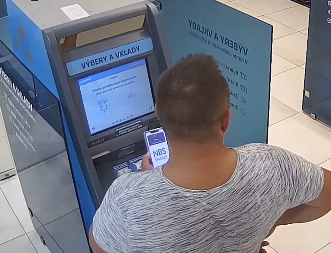 človek s mobilom vyberá peniaze, ale robí veľkú chybu. Veľkú. Chybu.