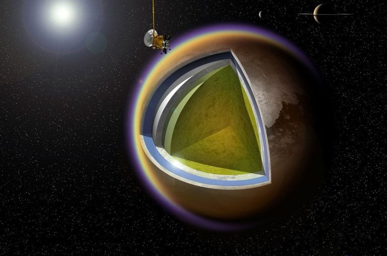 Umelecké stvárnenie vnútra mesiaca Titan so sondou Cassini v pozadí