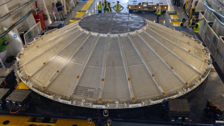 A flying saucer-shaped weather cover for the Artemis 3 SLS rocket.